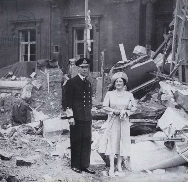 King George VI and Queen Elizabeth standing in the rubble of Buckingham Palace, London, after the